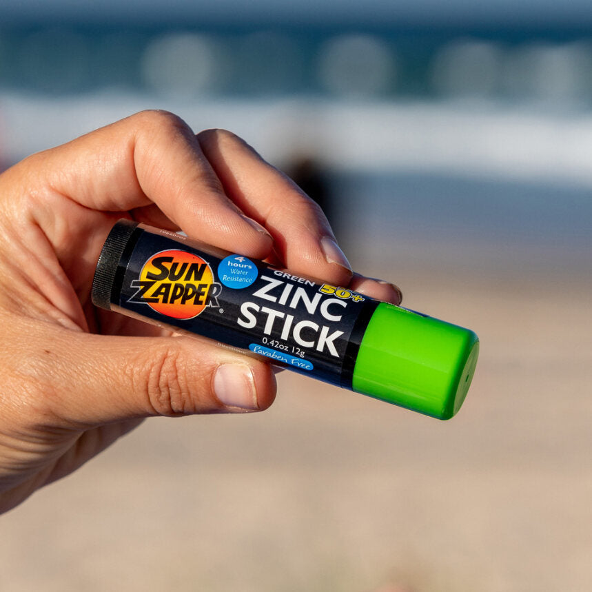 Sun Zapper Green Zinc Stick in hand at beach, Sun Zapper Zinc Sticks, Dunedin New Zealand