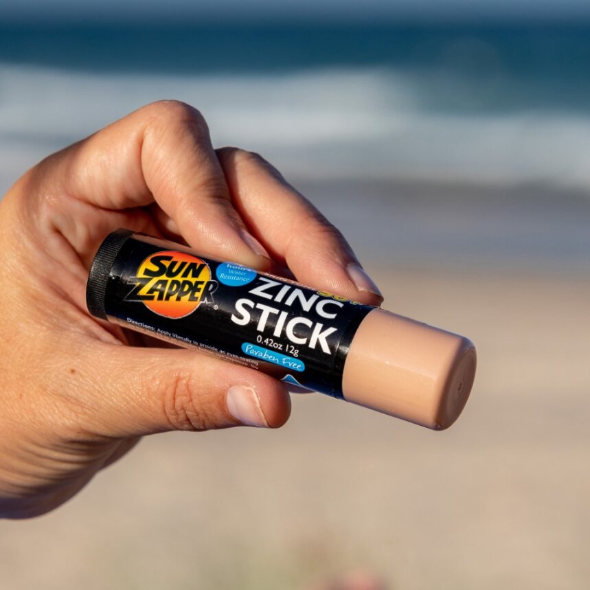 Sun Zapper Light Skin Tone Zinc Stick in hand at beach, Sun Zapper Zinc Sticks, Dunedin New Zealand
