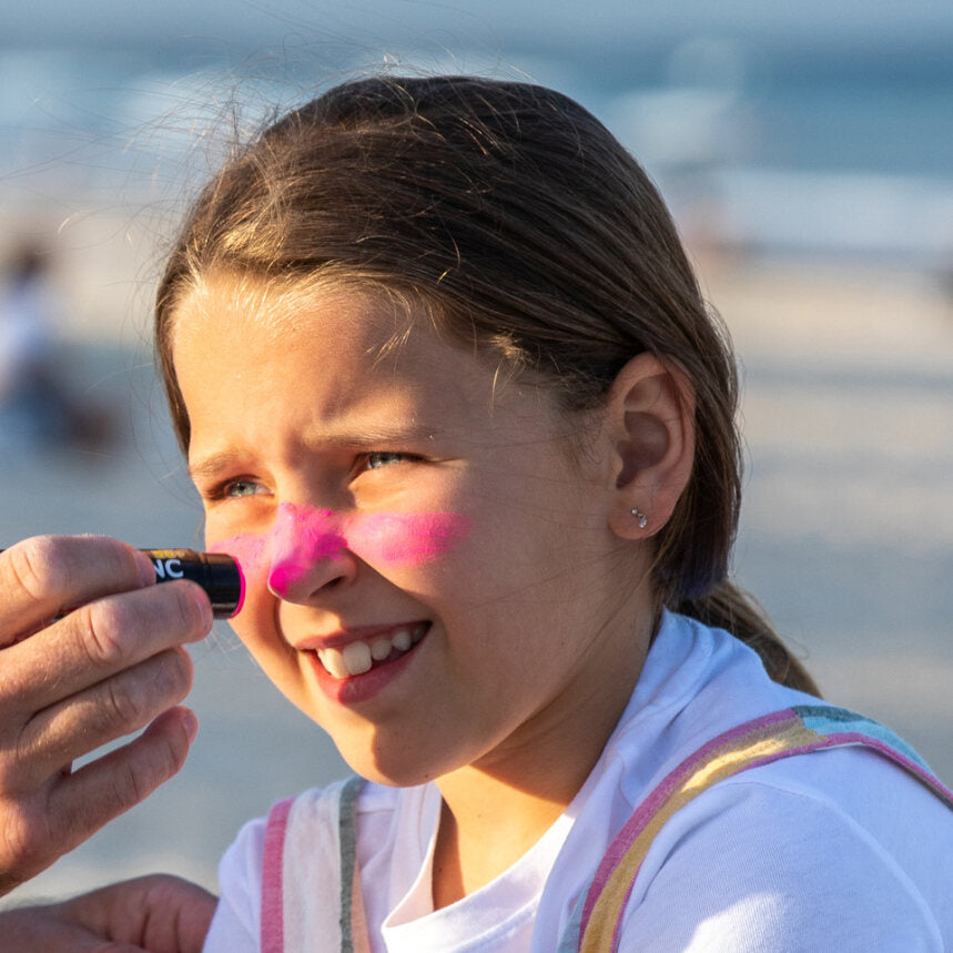 Sun Zapper Pink Zinc Stick on girl at beach, Sun Zapper Zinc Sticks, Dunedin New Zealand