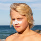 Sun Zapper White Zinc Stick on boy at beach, Sun Zapper Zinc Sticks, Dunedin New Zealand