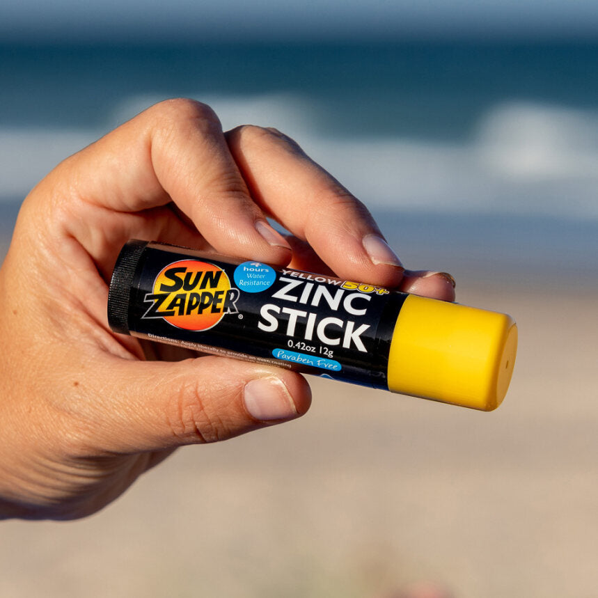 Sun Zapper Yellow Zinc Stick in hand at beach, Sun Zapper Zinc Sticks, Dunedin New Zealand