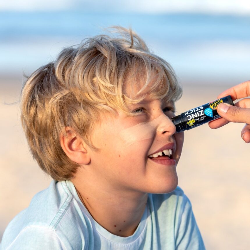 Sun Zapper light Skin Tone Zinc Stick on boy at beach, Sun Zapper Zinc Sticks, Dunedin New Zealand