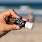 Sun Zapper White Zinc Stick in hand at beach, Sun Zapper Zinc Sticks, Dunedin New Zealand